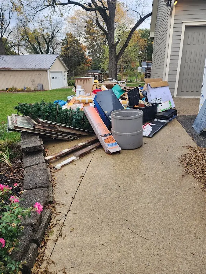 Dumpster being loaded with debris for Estate Cleanout Dumpster Rental in Fair Haven